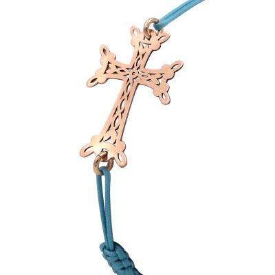 Bracelet Croix arménienne ajourée en or 18 carats, sur cordon turquoise. 1.44 gramme.